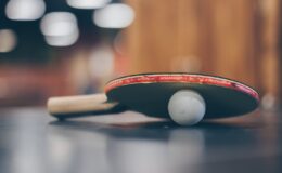 selective focus photo of table tennis ball and ping pong racket